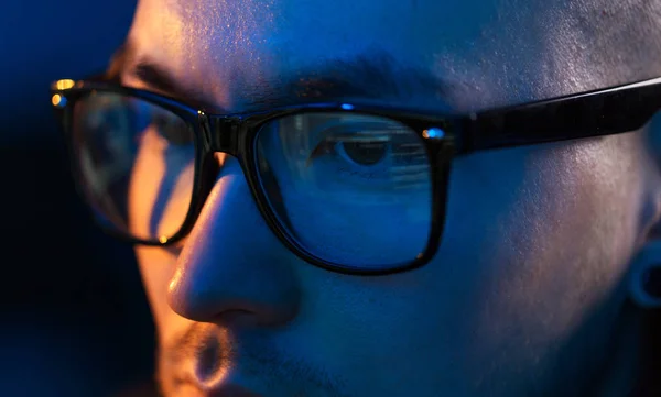 Close up of hacker in glasses looking at screen — Stock Photo, Image