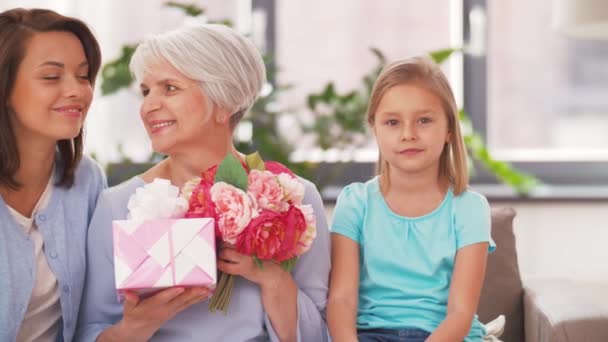 Porträtt av kvinnlig familj med blommor och gåva — Stockvideo