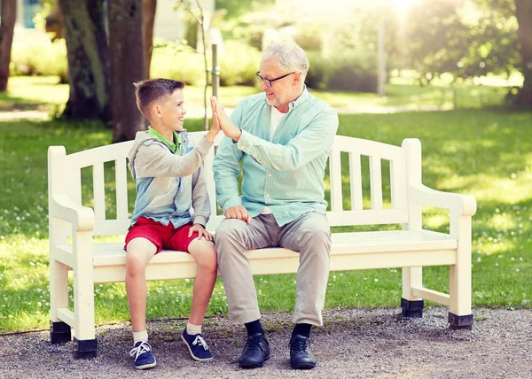 Yaşlı adam ve çocuk yaz Park'ta çak bir beşlik yapma — Stok fotoğraf