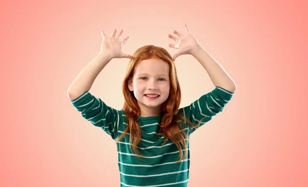 Red haired girl having fun and making big ears — Stock Photo, Image