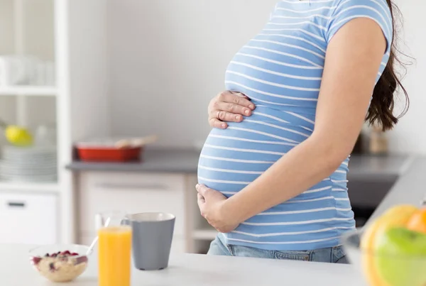 Primer plano de la mujer embarazada tocándose el vientre —  Fotos de Stock