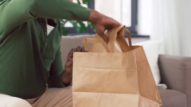 Indian man uppackning takeaway mat hemma — Stockvideo