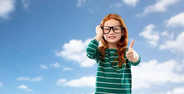 Red haired student girl in glasses over blue sky — Stock Photo, Image