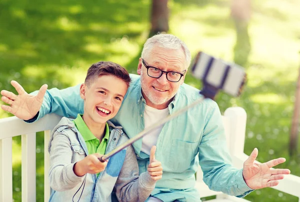 Old man and boy taking selfie by smartphone — Stock Photo, Image