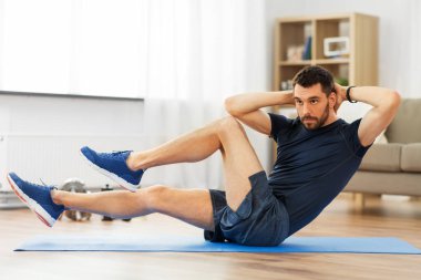 man making bicycle crunch exercise at home clipart