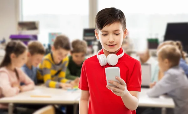 Boy in red t-shirt with headphones and smartphone — Stock Photo, Image