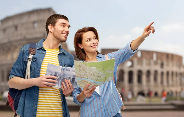 Happy couple of tourists with city guide and map — Stock Photo, Image