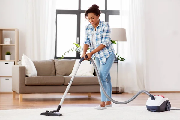 Woman or housewife with vacuum cleaner at home — Stock Photo, Image