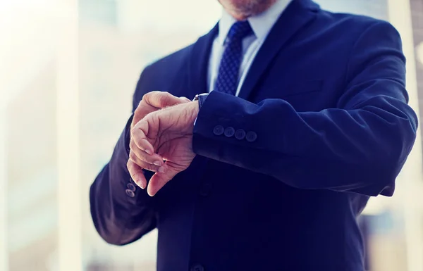 Hombre de negocios senior con reloj de pulsera en la calle de la ciudad — Foto de Stock