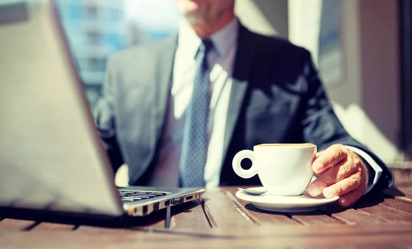 Empresário sênior com laptop e café ao ar livre — Fotografia de Stock