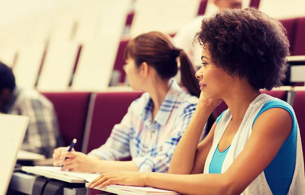 Group of students talking in lecture hall — Stock Photo, Image