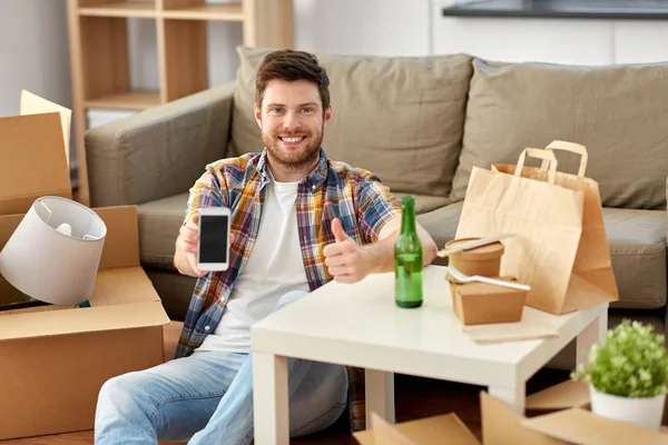 Man with smartphone and takeaway food moving — Stock Photo, Image