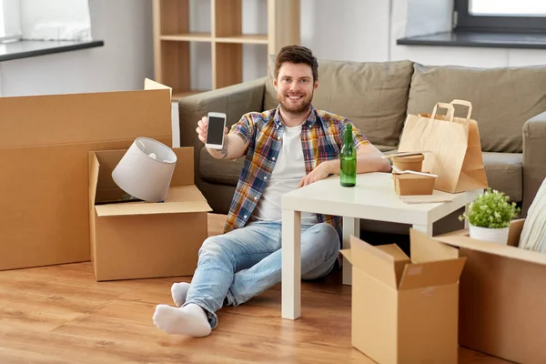 Man with smartphone and takeaway food moving — Stock Photo, Image