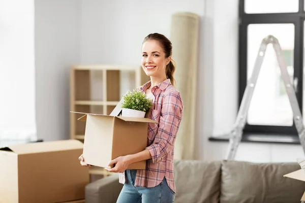 Happy woman with stuff moving to new home — Stock Photo, Image