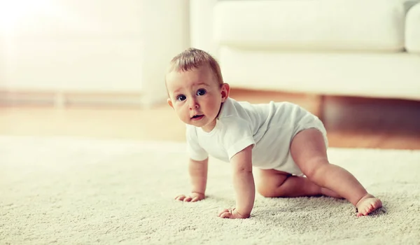 Little baby in diaper crawling on floor at home — Stock Photo, Image