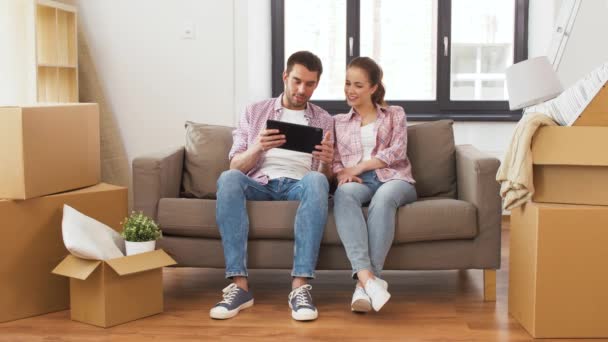 Happy couple with tablet pc computer at new home — Stock Video