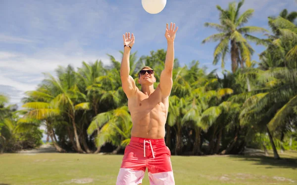 Jeune homme avec balle jouant au volley-ball sur la plage — Photo