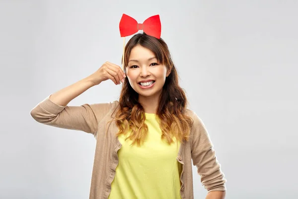 Happy asian woman with big red bow — Stock Photo, Image