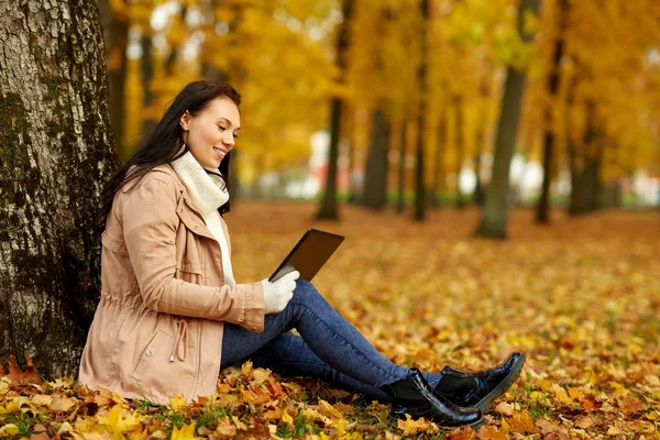 Mulher com computador tablet no parque de outono — Fotografia de Stock