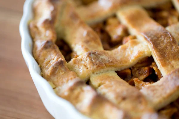 Close-up van appeltaart in schimmel op houten tafel — Stockfoto