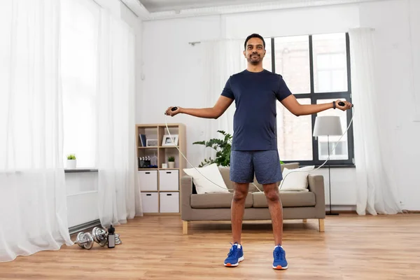Indian man exercising with jump rope at home — Stock Photo, Image