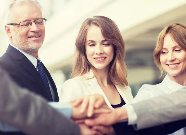 Business people putting hands on top in office — Stock Photo, Image