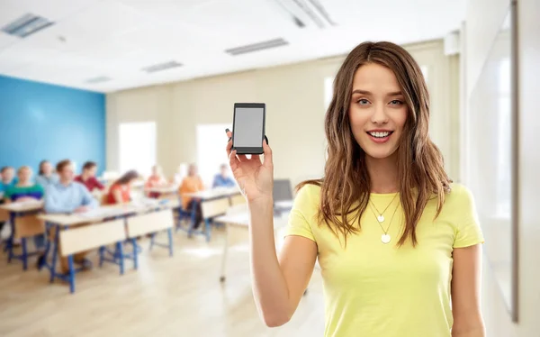 Teenage student girl holding smartphone at school — Stock Photo, Image