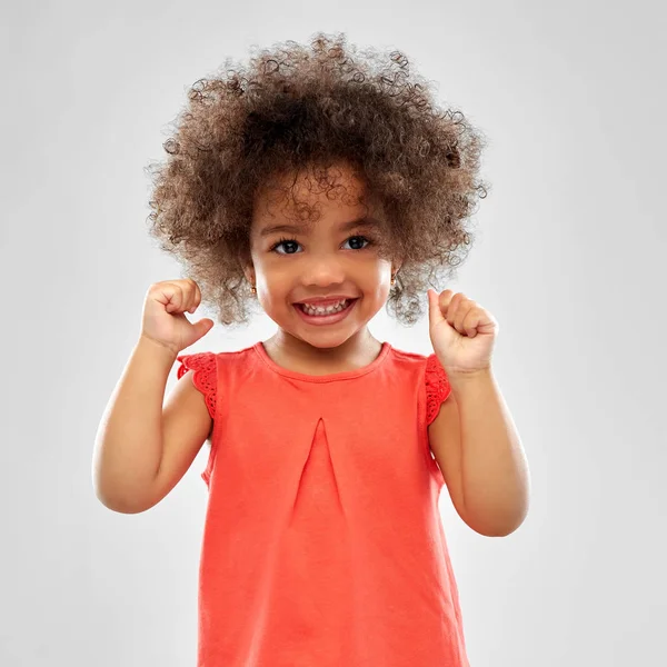 Happy little african american girl over grey — Stock Photo, Image