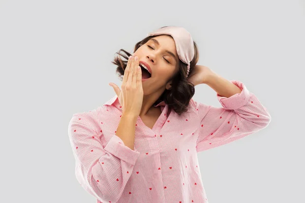 Happy young woman in pajama and eye sleeping mask — Stock Photo, Image