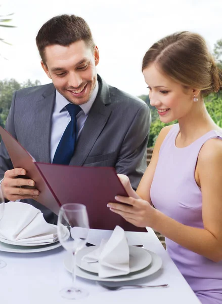 Couple with menu at restaurant — Stock Photo, Image