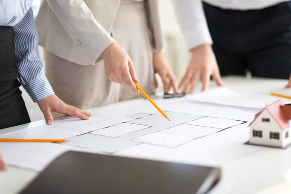 Close up of architects with blueprint at office — Stock Photo, Image