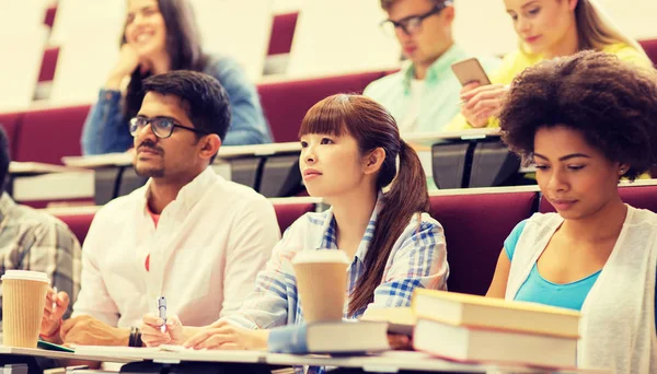 Group of students with notebooks on lecture — Stock Photo, Image