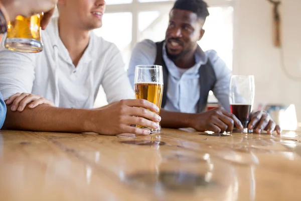 Male friends drinking beer at bar or pub — Stock Photo, Image