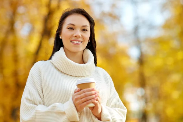 Kvinna dricka hämtmat kaffe i höstparken — Stockfoto