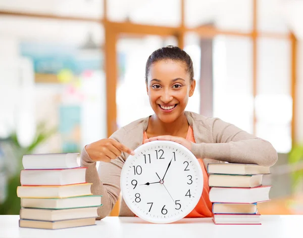 African american student with clock and books — Stock Photo, Image