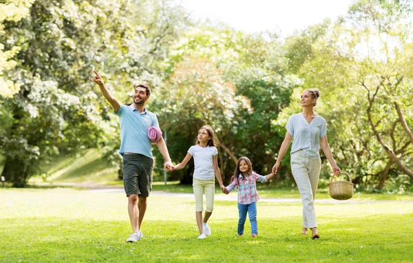 Familia con cesta de picnic caminando en el parque de verano —  Fotos de Stock