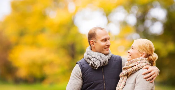 Casal sorridente no parque de outono — Fotografia de Stock