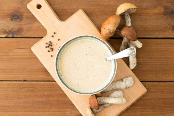 Mushroom cream soup in bowl on cutting board — Stock Photo, Image