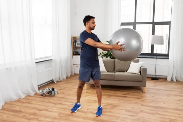 Indian man exercising with fitness ball at home — Stock Photo, Image