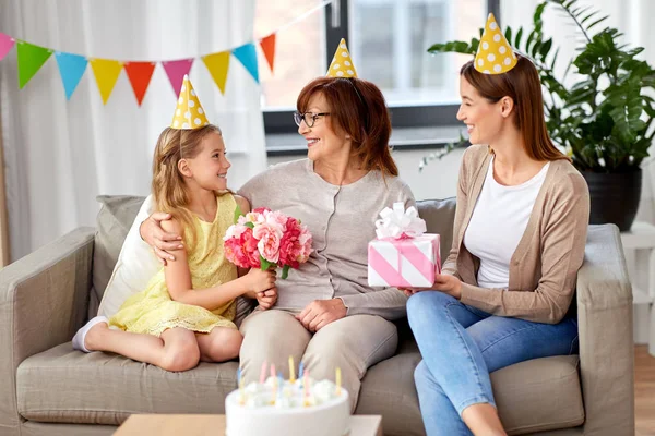 Granddaughter greeting grandmother on birthday — Stock Photo, Image