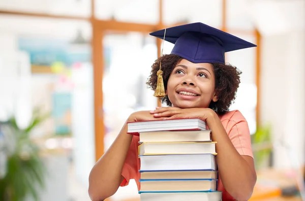 African american graduate student with books — Stock Photo, Image