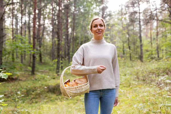 Mulher com cesta pegando cogumelos na floresta — Fotografia de Stock