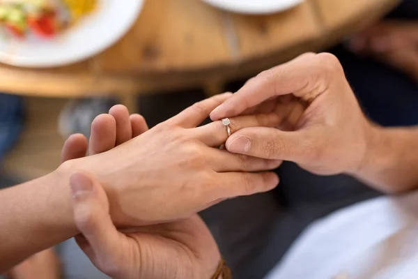 Homem dando anel de diamante para mulher no restaurante — Fotografia de Stock