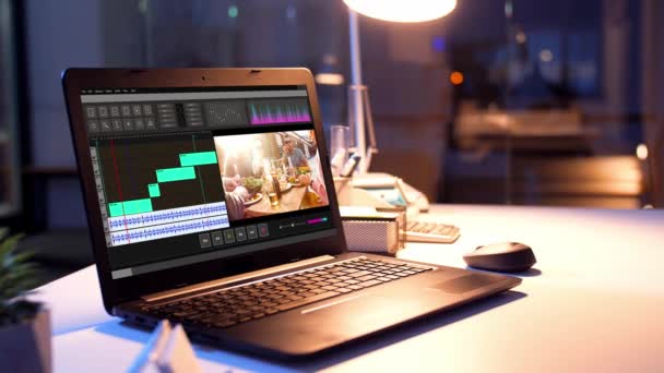 Programa editor de vídeo no laptop no escritório da noite — Vídeo de Stock