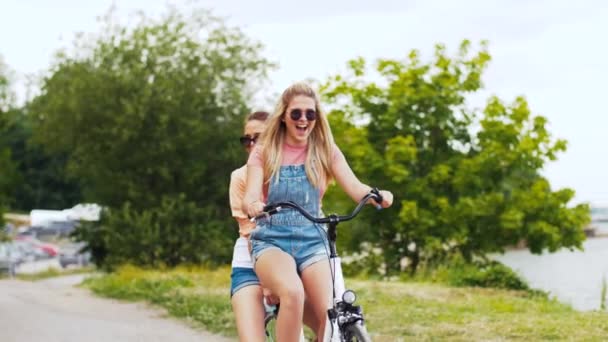 Tiener meisjes of vrienden paardrijden fiets in de zomer — Stockvideo