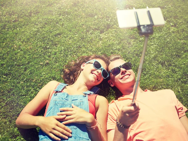 Счастливая пара делает селфи на смартфоне летом — стоковое фото