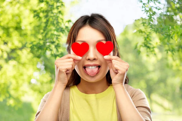 Woman with eyes of hearts over natural background — Stock Photo, Image