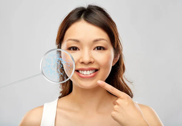 Happy smiling young asian woman touching her face — Stock Photo, Image