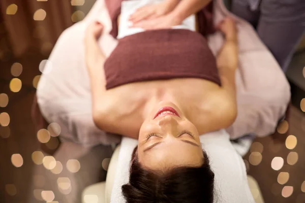 Mujer joven y feliz tumbada en el spa o salón de masajes — Foto de Stock