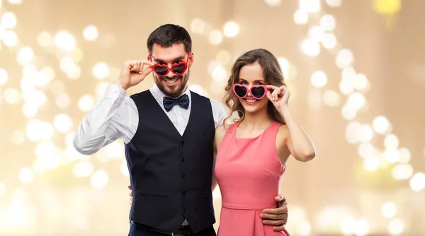 Happy couple in heart-shaped sunglasses — Stock Photo, Image